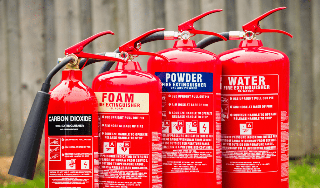 A picture of some fire extinguishers that have undergone a maintenance test.