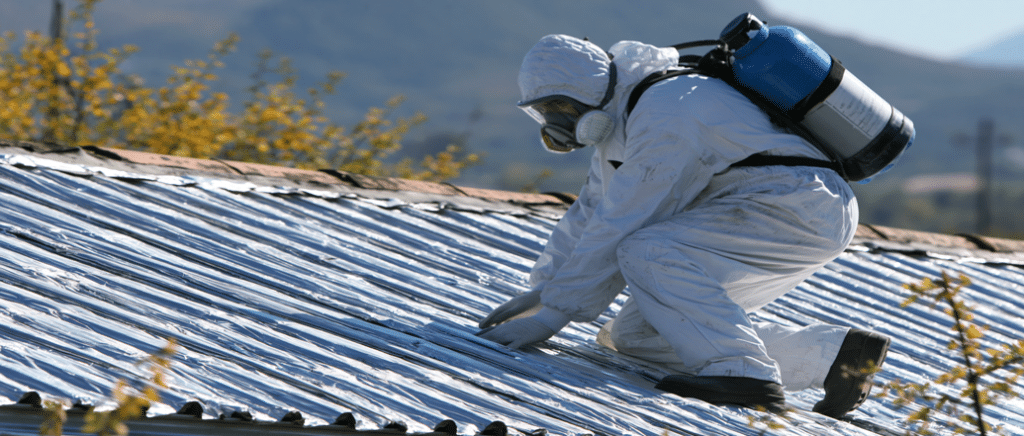 A picture of an asbestos worker on a rooftop.