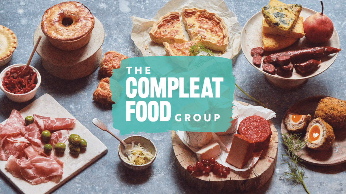 The Compleat Food Group logo displayed over a selection of prepared food products